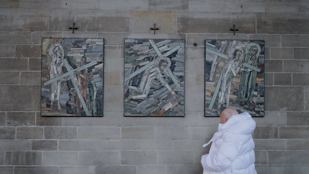 Still from «Anatomy of Non-Fact, Chapter 1», showing the Balenciaga pope decoding religious symbols. © Martyna Marciniak.