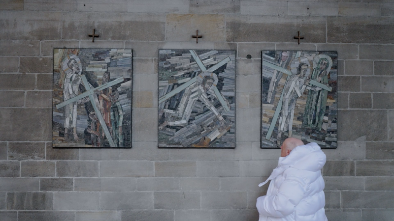 Still from «Anatomy of Non-Fact, Chapter 1», showing the Balenciaga pope decoding religious symbols. © Martyna Marciniak.